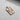 Rose gold-plated Silver Jack Pendant displayed on a concrete surface, with light casting a shadow to emphasize its depth.