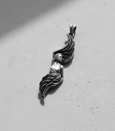 Angled view of the handcrafted Silver Angel Wing Pendant, emphasizing the oxidized finish and three-dimensional artistic form.