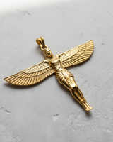 Gold-plated Egyptian Winged Goddess Pendant shown at an angle to highlight its polished finish and intricate details.