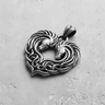 Oxidized sterling silver Celtic horse pendant showing two horses forming a heart with intricate knotwork on a gray surface.