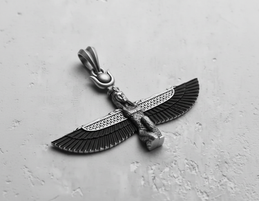 Sterling silver Egyptian Isis pendant with oxidized, detailed wings, shown on a light grey textured surface.