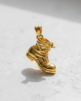 Gold vermeil over silver combat boot pendant showing detailed laces and rugged sole design on white background
