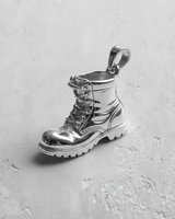 Highly polished 925 sterling silver combat boot pendant with a reflective finish, showcasing its clean lines and shape.