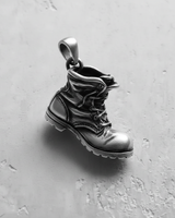 Top angle view of sterling silver combat boot pendant featuring polished toe and sturdy bail for chains