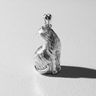 Rear view of 925 sterling silver sitting cat pendant showing textured fur details and curled tail design