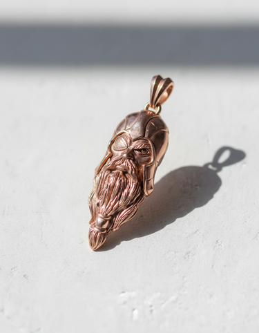 Rose-gold plated Silver Odin Pendant at an angle, displaying the intricate texture of the long beard and helmet.