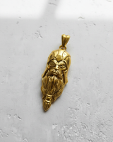 Gold-plated version of the Silver Odin Pendant, highlighting the fierce expression and single eye detail on a light background.