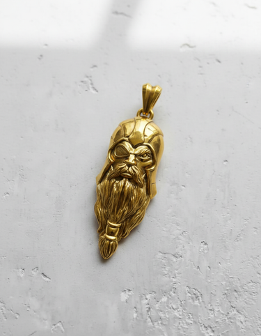 Gold-plated version of the Silver Odin Pendant, highlighting the fierce expression and single eye detail on a light background.