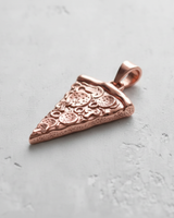 Rose gold plated version of the Silver Pizza Pendant showing detailed pepperoni toppings on a light gray concrete surface.