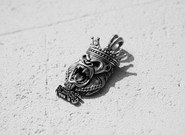 Close-up of the 925 sterling Silver Gorilla Pendant with deep shadows highlighting the crown and bared teeth details.