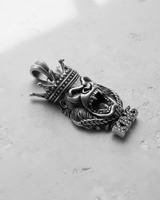 Handcrafted Silver Gorilla Pendant showing the oxidized finish and intricate fur texture, angled on a concrete surface.