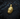 Gold plated silver gorilla head charm with intricate craftsmanship displayed on textured surface