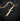 Angled view of gold vermeil face dagger pendant highlighting the artistic profile and blade craftsmanship