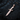 Face Dagger Pendant, rose gold, angled view on charred wood