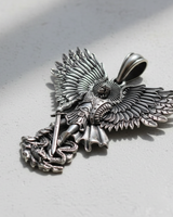 Silver Archangel Michael pendant with an oxidized finish, showing the detailed wings and sword subduing a dragon at its feet.