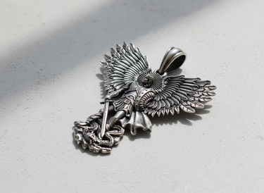 Silver Archangel Michael pendant with an oxidized finish, showing the detailed wings and sword subduing a dragon at its feet.