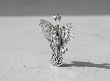 Front view of 925 sterling silver Archangel Michael pendant holding sword and shield defeating a dragon figure