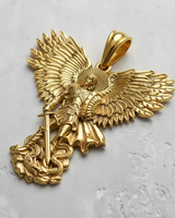 Angled view of the gold-plated St. Michael pendant, emphasizing the 3D craftsmanship of the warrior angel and defeated dragon.