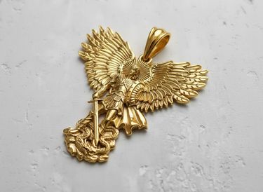 Angled view of the gold-plated St. Michael pendant, emphasizing the 3D craftsmanship of the warrior angel and defeated dragon.