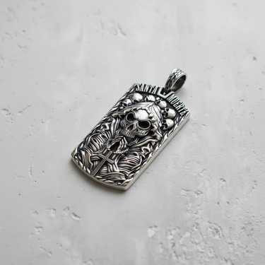 Angled view of silver Santa Muerte necklace pendant showing thickness and intricate engraving of the Holy Death figure