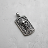 Angled view of silver Santa Muerte pendant showing hooded skull and praying hands relief