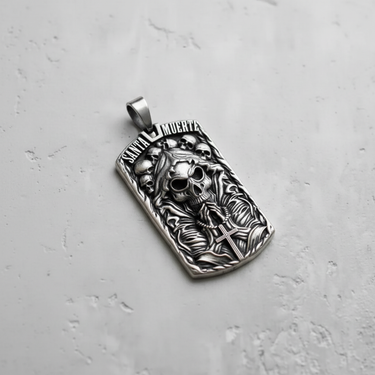 Angled view of silver Santa Muerte pendant showing hooded skull and praying hands relief