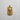 Gold vermeil Santa Muerte dog tag pendant with skull and rosary details on grey background