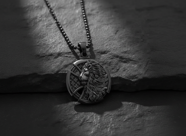 Silver Lion Cross Pendant with ball chain, showcasing the black rhodium plating and detailed relief on a dark slate.