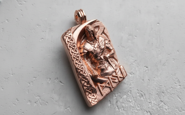 Rose gold-plated Viking warrior pendant angled to show the intricate craftsmanship of the Celtic and runic symbols.