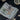 Astronaut money clip clipped onto cash on a gaming table with cards and chips