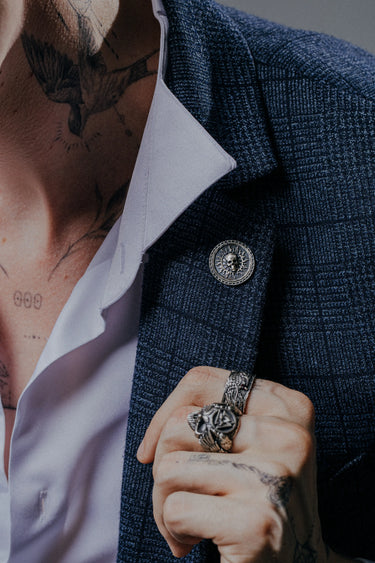 A man wearing the Solar Skull 925 sterling silver cufflinks, adding a bold and philosophical statement to his look.