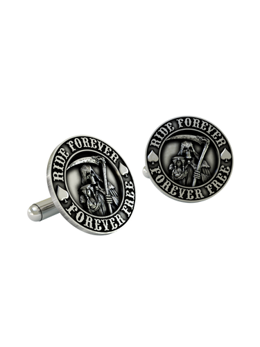 An extreme close-up of a Grim Reaper Cufflink, emphasizing the fine details of the scythe, hourglass, and bold lettering.