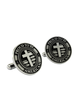 An extreme close-up of a Proud to be American Cufflink, emphasizing the fine details of the stars and stripes behind the polished cross.