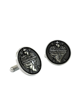An extreme close-up of a Sacred Heart Cufflink, emphasizing the fine details of the crown of thorns and the emanating divine light.