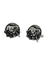 An extreme close-up of a Silver Bull Cufflink, emphasizing the intricate details of the sculpted form and textured base.