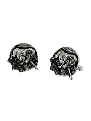 An extreme close-up of a Silver Bull Cufflink, emphasizing the intricate details of the sculpted form and textured base.