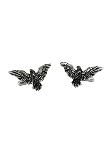 An extreme close-up of a Silver Eagle Cufflink, emphasizing the intricate texture and layers of the sculpted feathers.