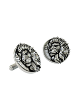 An extreme close-up of a Silver Lion Cufflink, emphasizing the intricate details of the mane and the savanna scene.