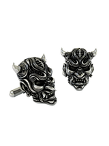 An extreme close-up of a Silver Oni Mask Cufflink, emphasizing the intricate textures, polished fangs, and expert craftsmanship.