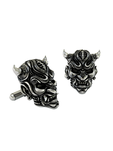 An extreme close-up of a Silver Oni Mask Cufflink, emphasizing the intricate textures, polished fangs, and expert craftsmanship.