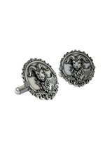 An extreme close-up of a Silver Ram Cufflink, emphasizing the fine details of the ram's face, horns, and the baroque-style frame.