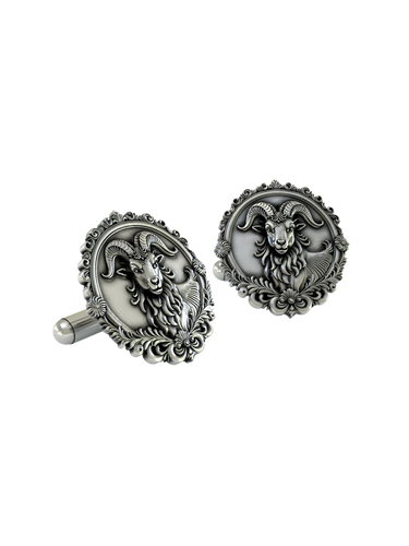 An extreme close-up of a Silver Ram Cufflink, emphasizing the fine details of the ram's face, horns, and the baroque-style frame.