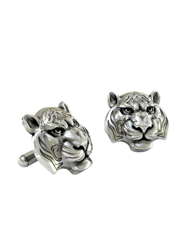 An extreme close-up of a Silver Tiger Cufflink, emphasizing the fine details of the eyes, polished finish, and oxidized stripes.