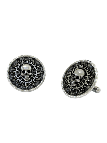 An extreme close-up of a Solar Skull Cufflink, emphasizing the contrast between the smooth skull and the textured, sunburst background.