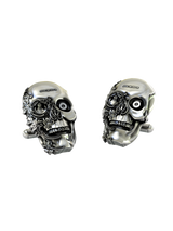 An extreme close-up of a Steampunk Skull Cufflink, emphasizing the fine details of the pyramid mechanism and engraved floral work.