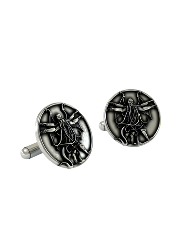 An extreme close-up of a sterling silver Cthulhu Cufflink, emphasizing the fine details of the tentacles, wings, and humanoid form.