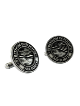 An extreme close-up of an Air Force Cufflink, emphasizing the fine details of the jets and the bold, clear lettering.