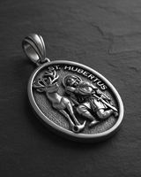 Angled detail of Saint Hubert Medal Pendant sterling silver pendant highlighting intricate stag antlers and crucifix between horns