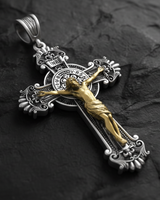 Angled detail view of Saint Benedict Crucifix Pendant two-tone cross showing INRI plaque and baroque ornamental elements