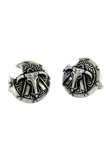 Angled profile view of the Greek warrior sterling silver cufflinks, highlighting the 3D relief of the central crest and shield texture.